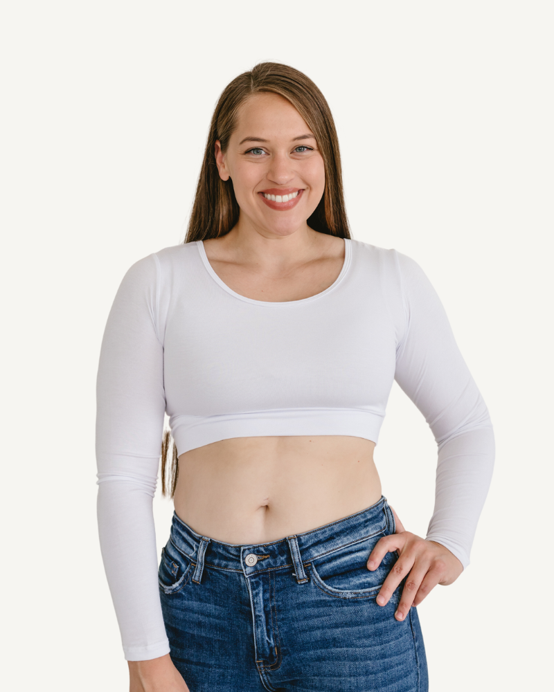 A woman in a white crop top and jeans, wearing a Classic Long Sleeve Halftee.