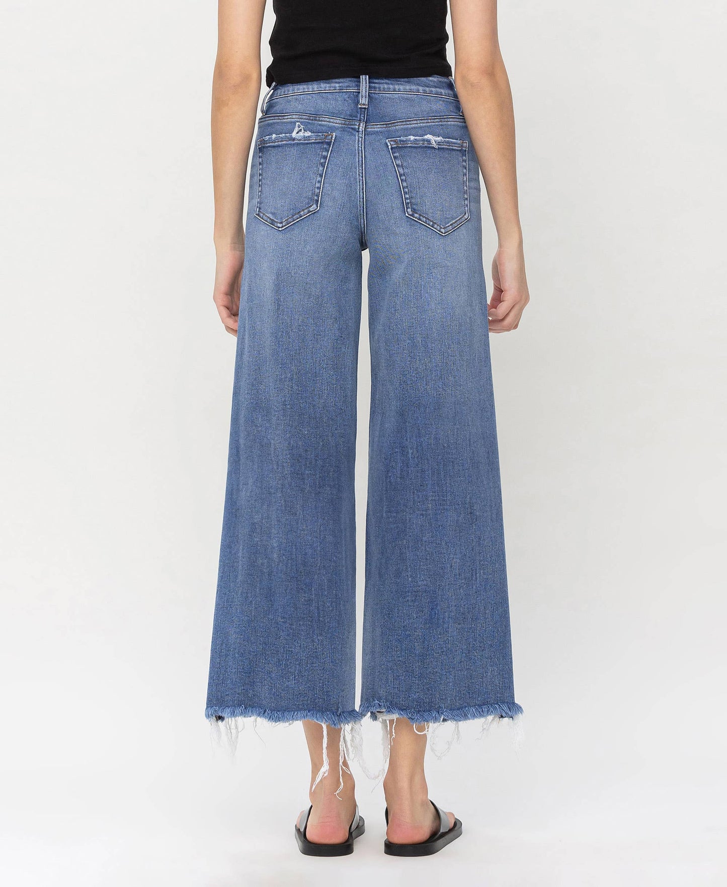 High-waisted denim jeans with frayed hems, crafted for fashionable layering by HALFTEE Layering Fashions.