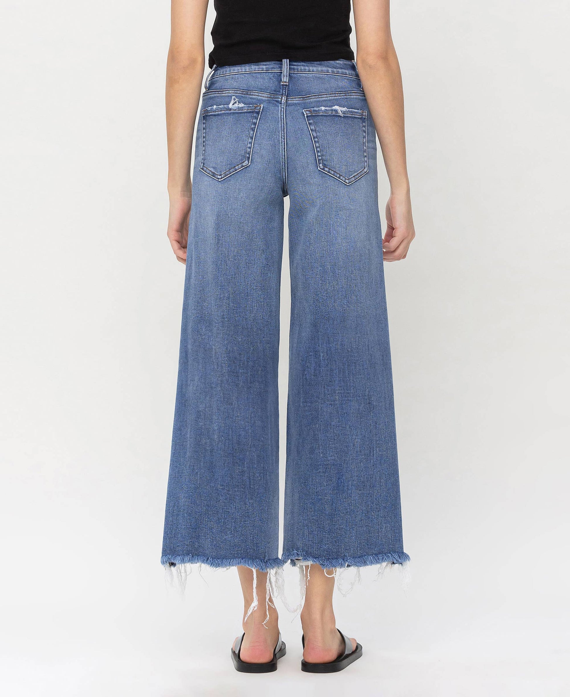 High-waisted denim jeans with frayed hems, crafted for fashionable layering by HALFTEE Layering Fashions.