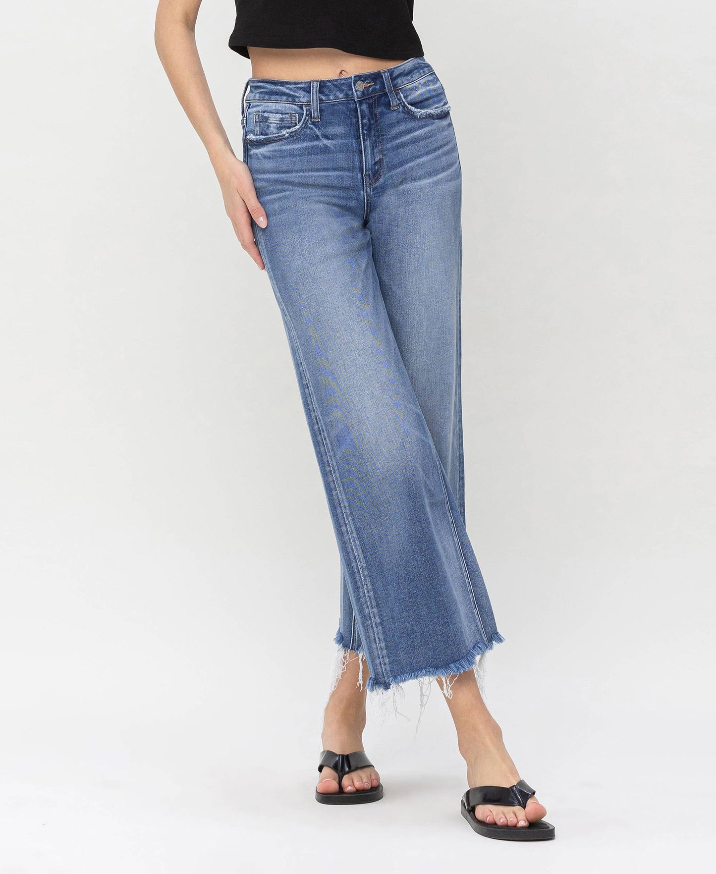 High-waisted denim jeans with frayed hems, perfect for layering with HALFTEE Layering Fashions.