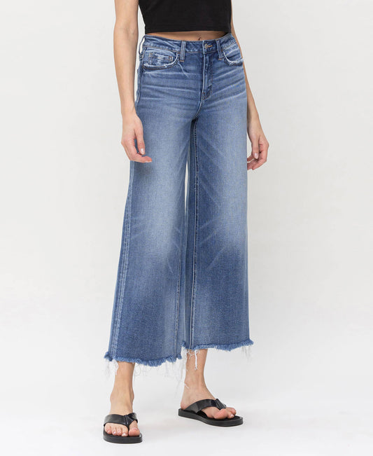 High-waisted denim jeans featuring frayed hems, designed for stylish layering by HALFTEE Layering Fashions.