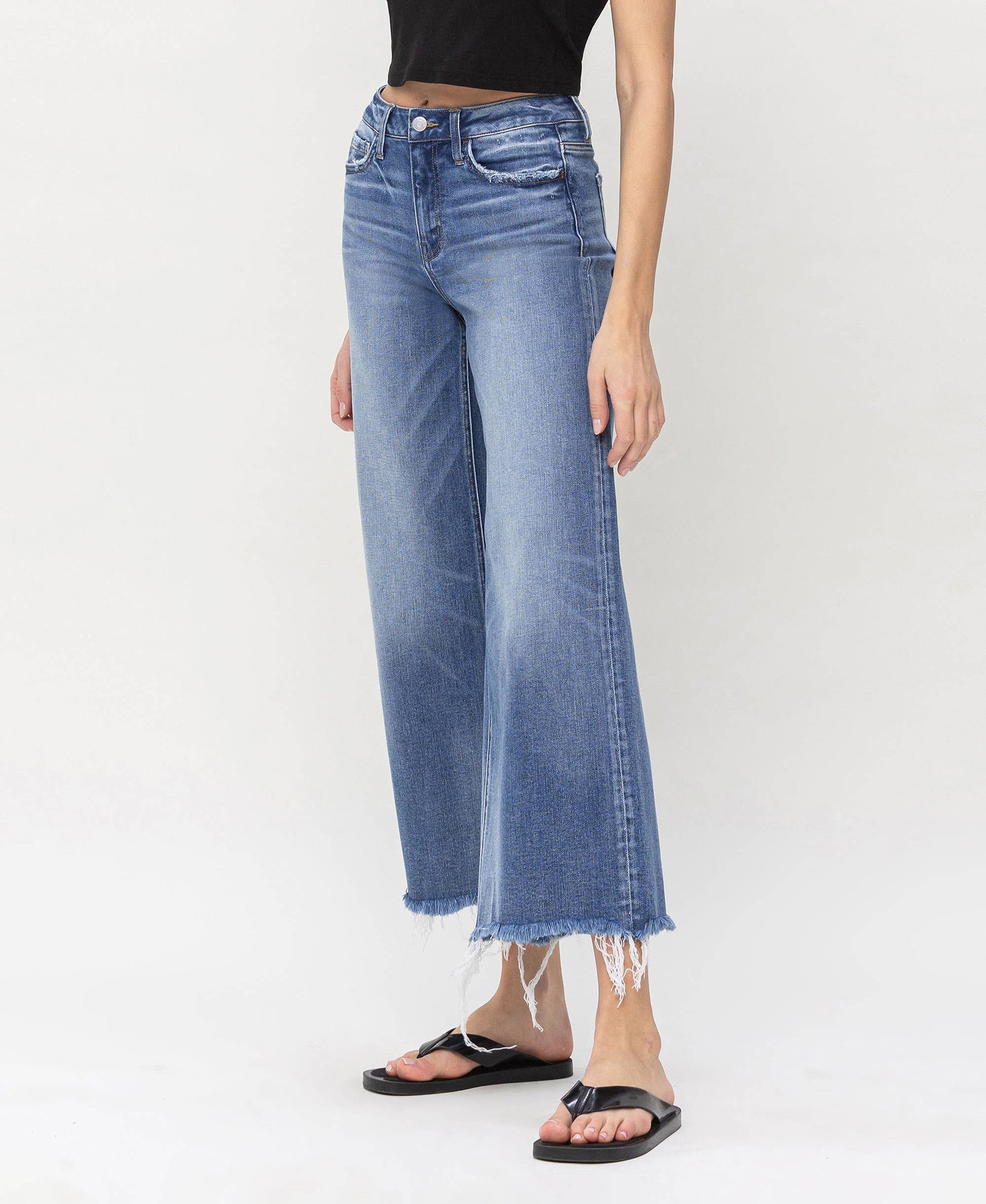 High-rise denim jeans with frayed edges, designed for stylish layering by HALFTEE Layering Fashions.