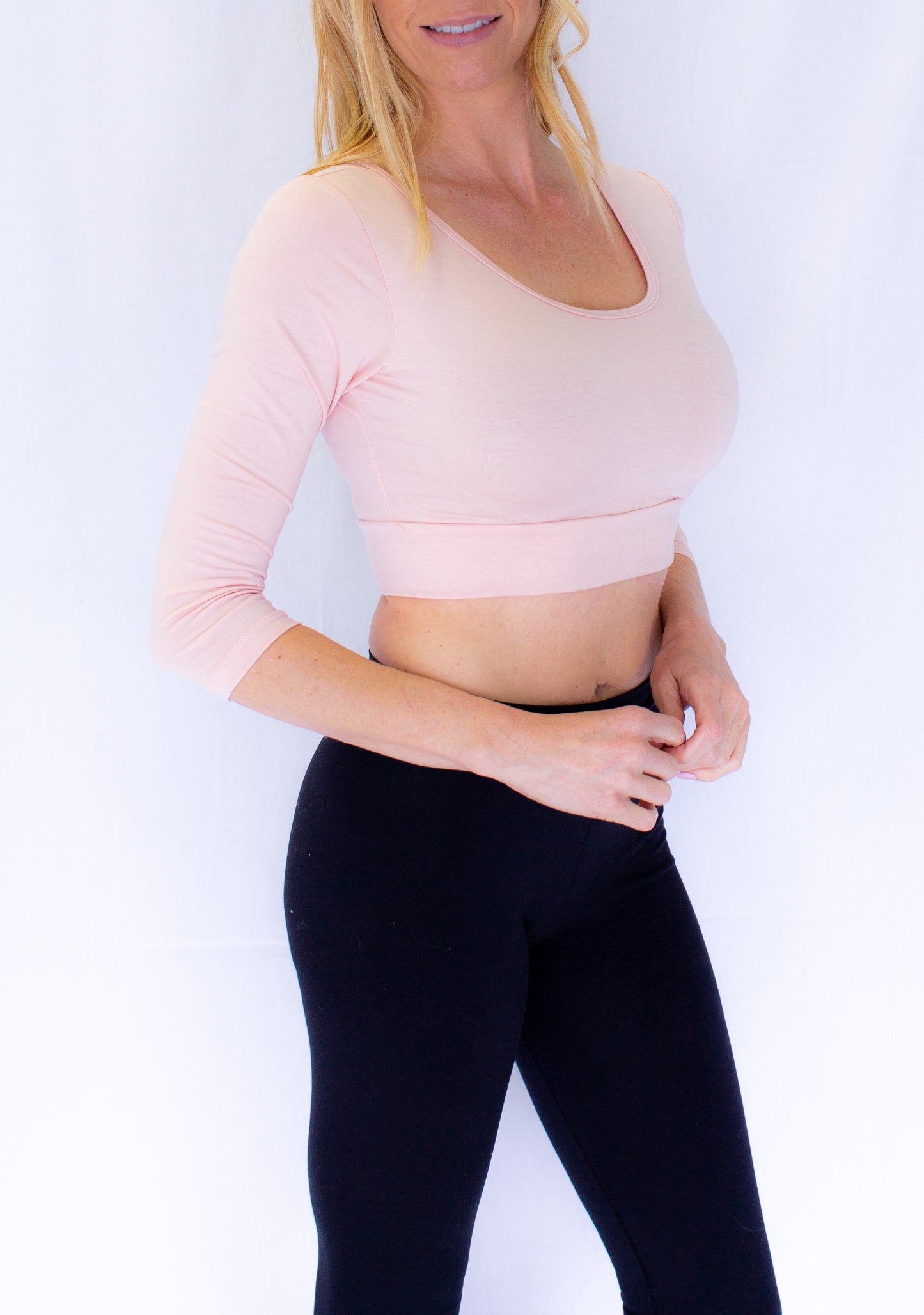 A woman wearing jeans and a crop top, showcasing The Classic 3/4 Sleeve Halftee - NEUTRALS.