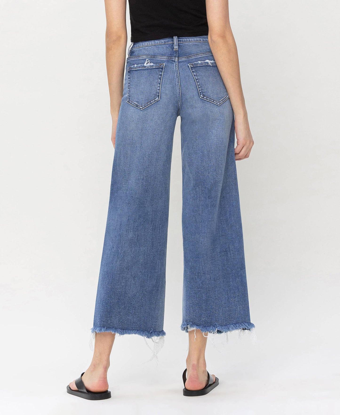 Stylish high rise jeans made from denim with frayed edges, ideal for layering by HALFTEE Layering Fashions.