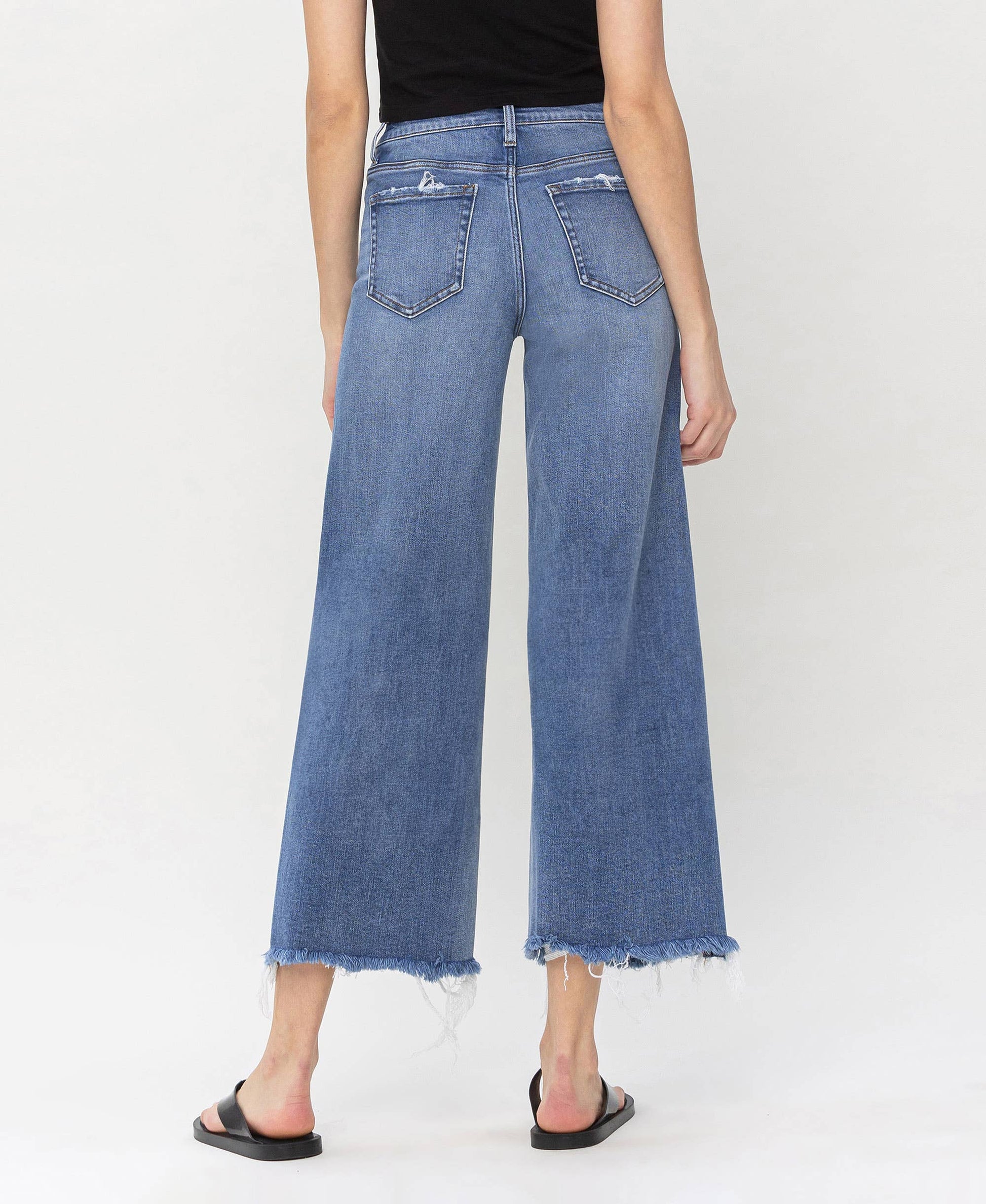Stylish high rise jeans made from denim with frayed edges, ideal for layering by HALFTEE Layering Fashions.