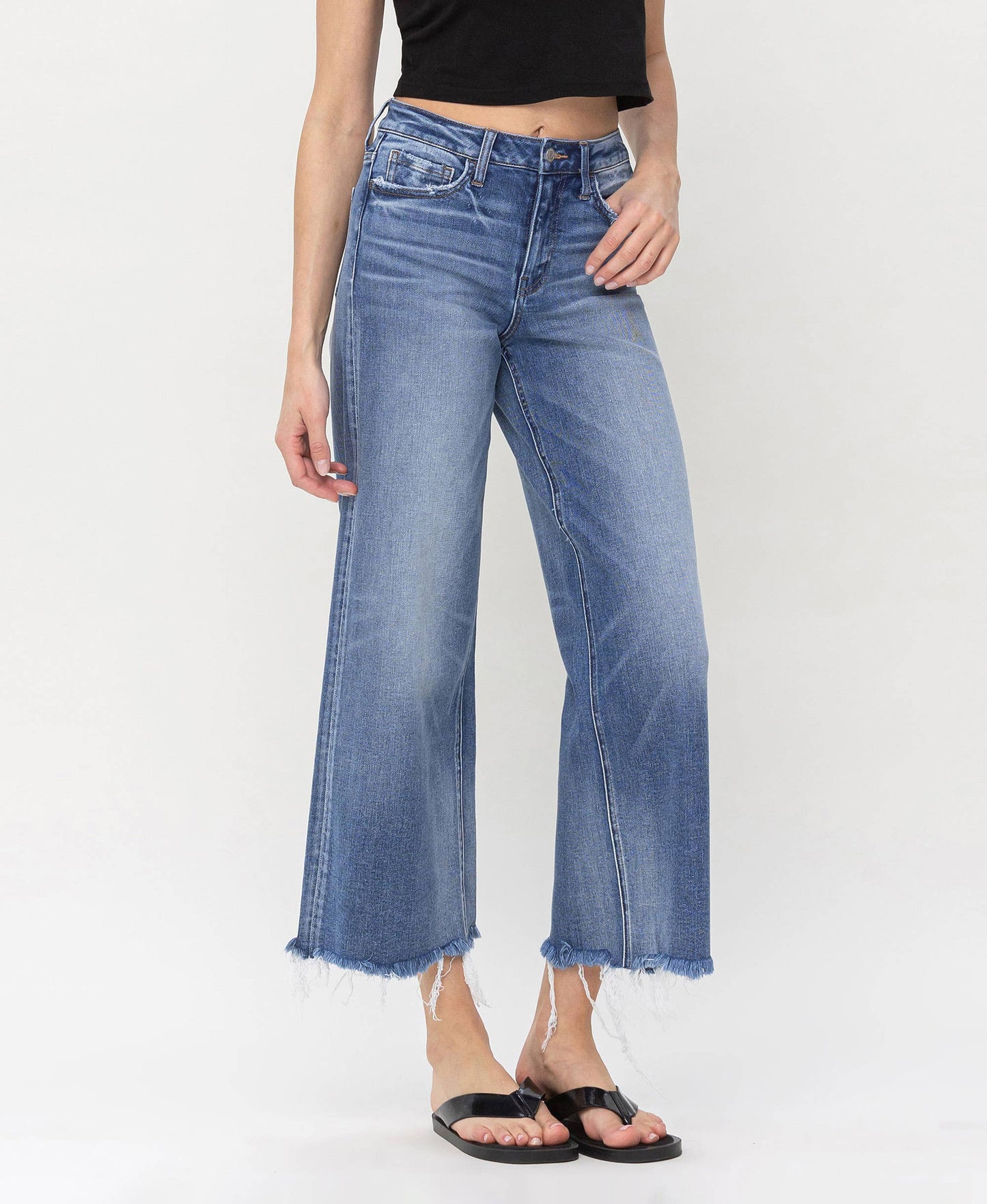 Trendy high-waisted denim jeans with frayed edges, ideal for layering by HALFTEE Layering Fashions.