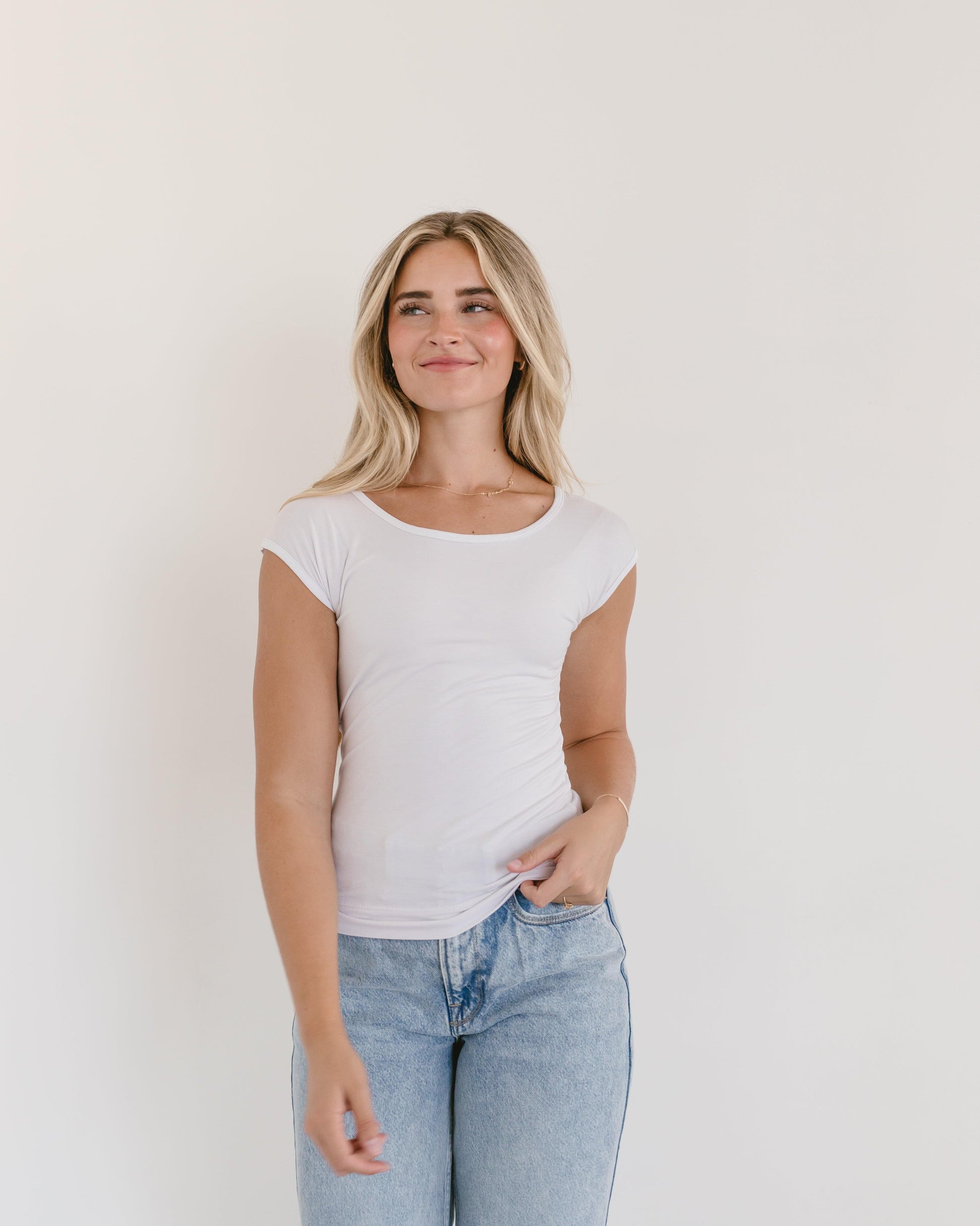 A model in a white t-shirt and jeans, showcasing a Basic Cap Sleeve Full-Length outfit.