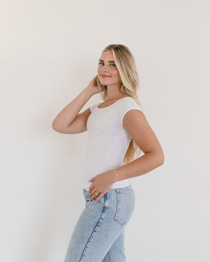 A model in a white t-shirt and jeans, showcasing a Basic Cap Sleeve Full-Length outfit.