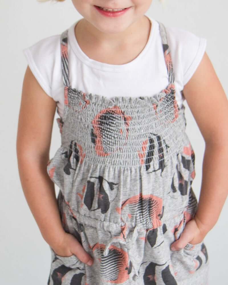 Young girl in grey and white cat print dress, Girlee Basic Cap Sleeve.