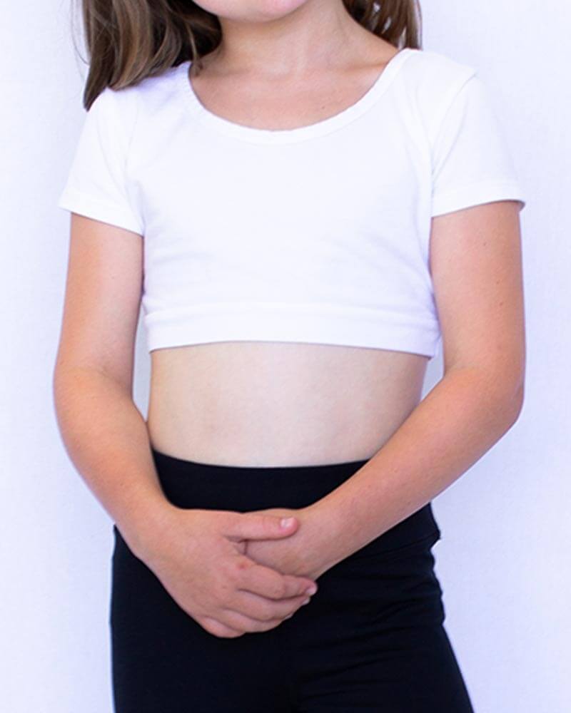 A young girl in a white shirt and jeans, standing next to a sign that reads 'GIRLEE Boyfriend'.