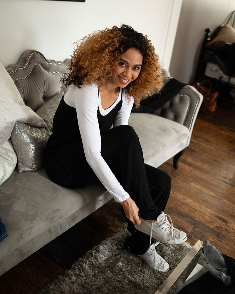 A woman in a white crop top and jeans, wearing a Classic Long Sleeve Halftee. 