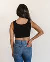Woman in black crop top and jeans, wearing Classic Wide Strap Tank Halftee.
