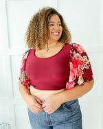 Plus size coral floral top with waterfall sleeves, perfect for any occasion.